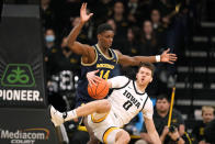 Iowa forward Filip Rebraca (0) falls to the court ahead of Michigan forward Moussa Diabate (14) during the first half of an NCAA college basketball game, Thursday, Feb. 17, 2022, in Iowa City, Iowa. (AP Photo/Charlie Neibergall)