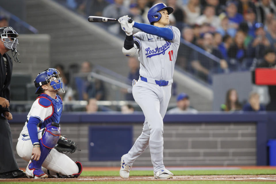 TORONTO, ONTARIO, CANADA - APRIL 26: Shohei Ohtani #17 of the Los Angeles Dodgers hits a solo home run during the first inning of their MLB game against the Toronto Blue Jays at Rogers Centre on April 26, 2024 in Toronto, Canada. (Photo by Cole Burston/Getty Images)