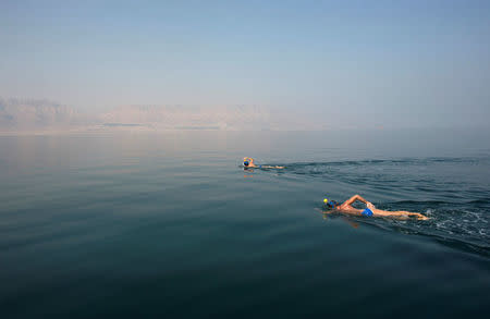 Environmental activists take part in "The Dead Sea Swim Challenge", swimming from the Jordanian to Israeli shore, to draw attention to the ecological threats facing the Dead Sea, in Kibbutz Ein Gedi, Israel November 15, 2016. REUTERS/Nir Elias