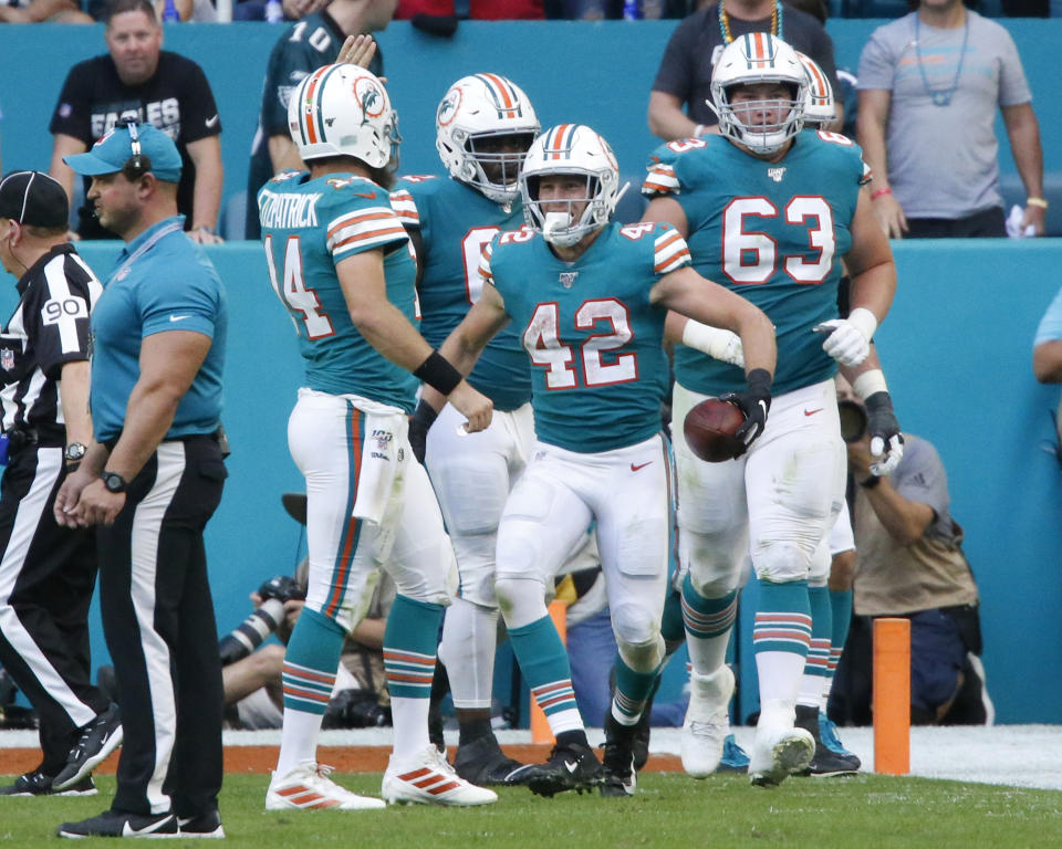 MIAMI GARDENS, FL - DECEMBER 1: Teammates congratulate Patrick Laird #42 of the Miami Dolphins after he scored a touchdown against the Philadelphia Eagles during an NFL game on December 1, 2019 at Hard Rock Stadium in Miami Gardens, Florida. The Dolphins defeated the Eagles 37-31. (Photo by Joel Auerbach/Getty Images)