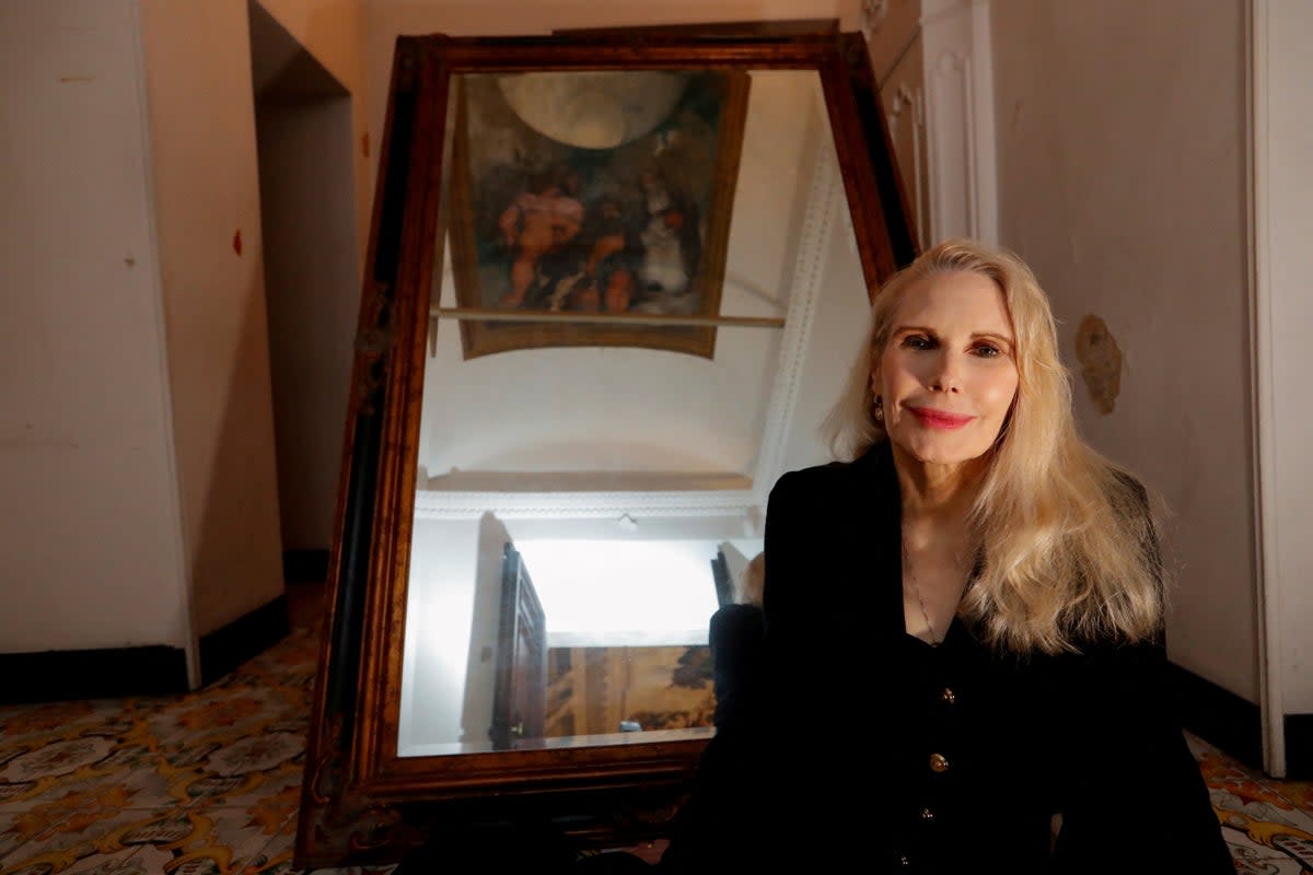 Princess Rita Boncompagni Ludovisi poses for a photograph below Caravaggio's only ceiling mural inside Villa Aurora, in Rome, Italy, November 16, 2021. (Reuters)