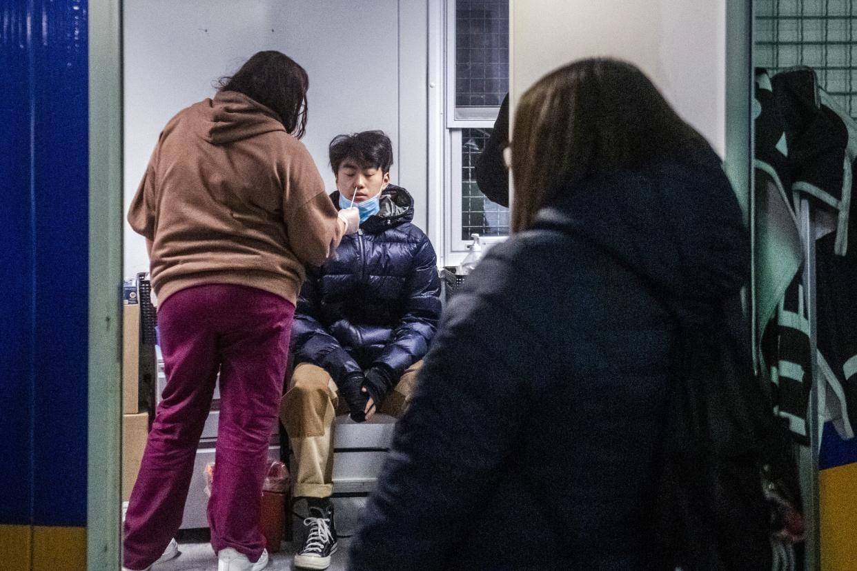 A man swabbed during a COVID-19 test on the Lower East Side of Manhattan, Tuesday, Dec. 21, in New York. 