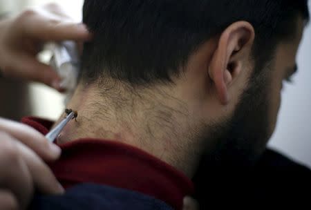 A Palestinian patient, who suffers from nerve problems in his neck and back, receives bee-sting therapy at Rateb Samour's clinic in Gaza City April 11, 2016. REUTERS/Suhaib Salem