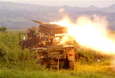 Rockets are fired from a Congolese army vehicle in the direction of M23 rebels in Kibumba, north of Goma October 27, 2013. REUTERS/Kenny Katombe