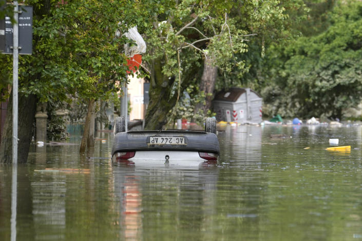 A car is submerged in Faenza, Italy, Thursday, May 18, 2023. Exceptional rains Wednesday in a drought-struck region of northern Italy swelled rivers over their banks, killing at least nine people, forcing the evacuation of thousands and prompting officials to warn that Italy needs a national plan to combat climate change-induced flooding. (AP Photo/Luca Bruno)