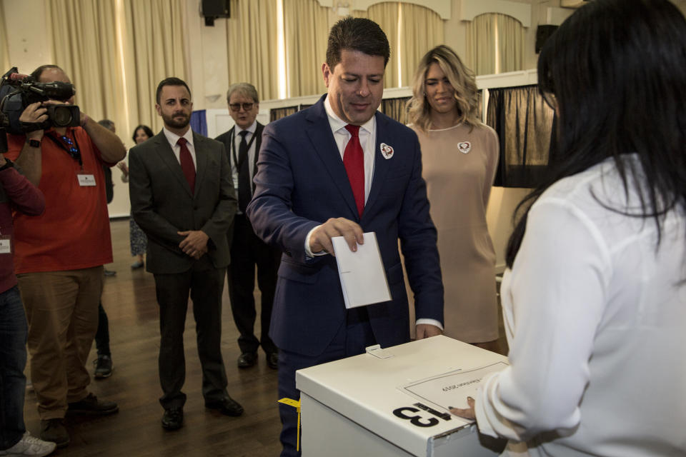 Chief Minister of Gibraltar Fabian Picardo places his vote during general elections in Gibraltar, Thursday Oct. 17, 2019. An election for Gibraltar's 17-seat parliament is taking place Thursday under a cloud of uncertainty about what Brexit will bring for this British territory on Spain's southern tip. (AP Photo/Javier Fergo)