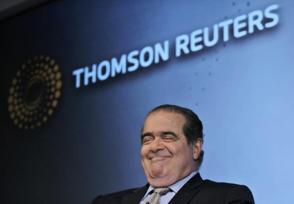 Antonin Scalia in front of a sign saying Thomson Reuters