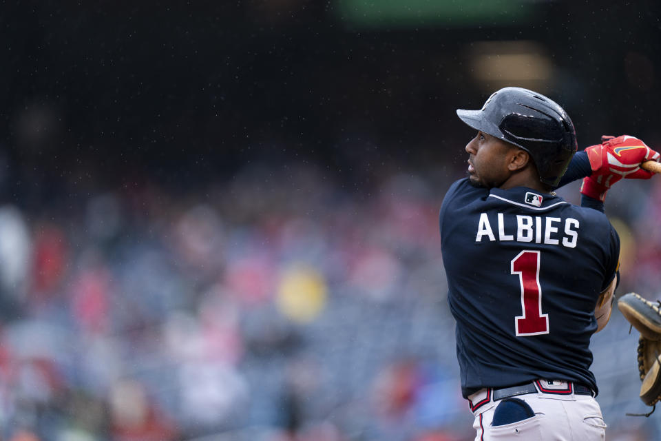 Atlanta Braves' Ozzie Albies watches his foul ball in the rain during the fourth inning of a baseball game against the Washington Nationals, Sunday, Sept. 24, 2023, in Washington. (AP Photo/Stephanie Scarbrough)
