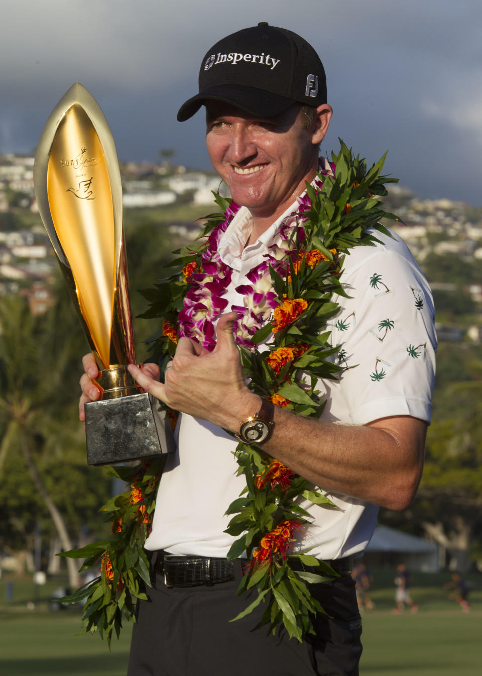 Jimmy Walker poses for photos with the Sony Open trophy after winning the golf tournament at Waialae Country Club, Sunday, Jan. 12, 2014, in Honolulu. (AP Photo/Eugene Tanner)