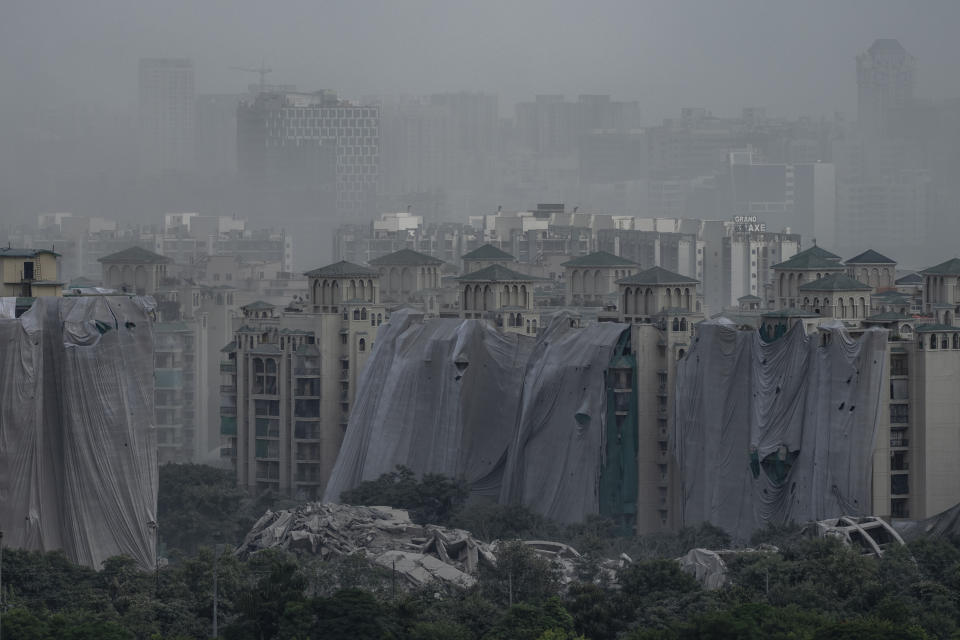 Debris is seen after twin high-rise apartment towers are leveled to the ground in a controlled demolition in Noida, outskirts of New Delhi, India, Sunday, Aug. 28, 2022. The demolition was done after the country's top court declared them illegal for violating building norms. The 32-story and 29-story towers, constructed by a private builder were yet to be occupied and became India's tallest structures to be razed to the ground. (AP Photo/Altaf Qadri)