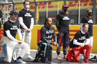 Mercedes driver Lewis Hamilton of Britain, center and other drivers rivers kneel during the anti-racism demonstration ahead of the British Formula One Grand Prix at the Silverstone racetrack, Silverstone, England, Sunday, Aug. 2, 2020. (Bryn Lennon/Pool via AP)