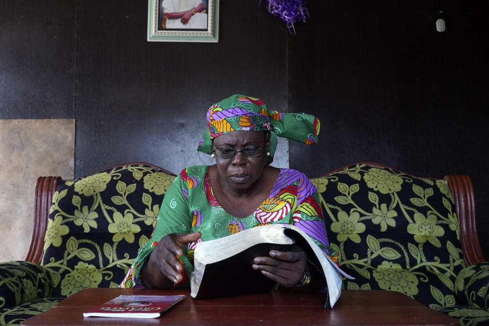 Arowolo Mofeoluwa Victoria, a retired Civil Servant , who claimed she has lost two houses due to coastal erosion, reads a bible inside her house in Ayetoro, Southwest Nigeria, Friday, April 5, 2024. Ayetoro, a coastal community more than 200 km southeast of Nigeria's business capital Lagos, has been experiencing coastal erosion for many years. But the changes have recently rapidly worsened with the community slumping into the Atlantic Ocean, leading to repeated displacements of households and businesses. (AP Photo/Dan Ikpoyi)