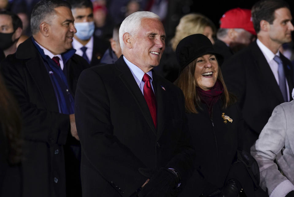 Vice President Mike Pence and his wife Karen listen as President Donald Trump speaks during a campaign rally at Gerald R. Ford International Airport, early Tuesday, Nov. 3, 2020, in Grand Rapids, Mich. (AP Photo/Evan Vucci)