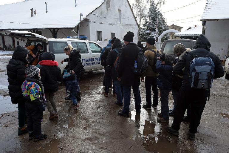 Kosovo Albanians arrive at a police station after being arrested as they tried to illegally cross the border near the northern Serbian city of Subotica, close to the Hungarian border, on February 9, 2015