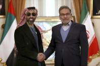 Secretary of Iran's Supreme National Security Council Ali Shamkhani, right, and United Arab Emirates' top national security adviser Sheikh Tahnoon bin Zayed Al Nahyan shake hands for the media prior to their meeting in Tehran, Iran, Monday, Dec. 6, 2021. Sheikh Tahnoon's visit comes as the Emirates and Saudi Arabia both negotiate with Iran amid efforts in Vienna to save Tehran’s tattered nuclear deal with world powers. (AP Photo/Vahid Salemi)