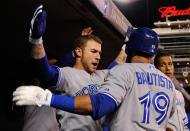 MINNEAPOLIS, MN - MAY 11: Brett Lawrie #13 of the Toronto Blue Jays congratulates Jose Bautista #19 on a solo home run against the Minnesota Twins during the first inning on May 11, 2012 at Target Field in Minneapolis, Minnesota. (Photo by Hannah Foslien/Getty Images)