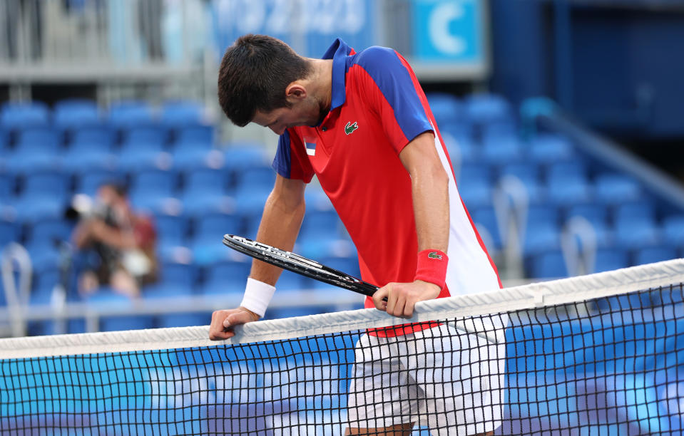 <p>TOKYO, JAPAN - JULY 31: Novak Djokovic of Team Serbia reacts at match point to be defeated by Pablo Carreno Busta of Team Spain during the Men's Singles Bronze Medal Match on day eight of the Tokyo 2020 Olympic Games at Ariake Tennis Park on July 31, 2021 in Tokyo, Japan. (Photo by Amin Mohammad Jamali/Getty Images)</p> 