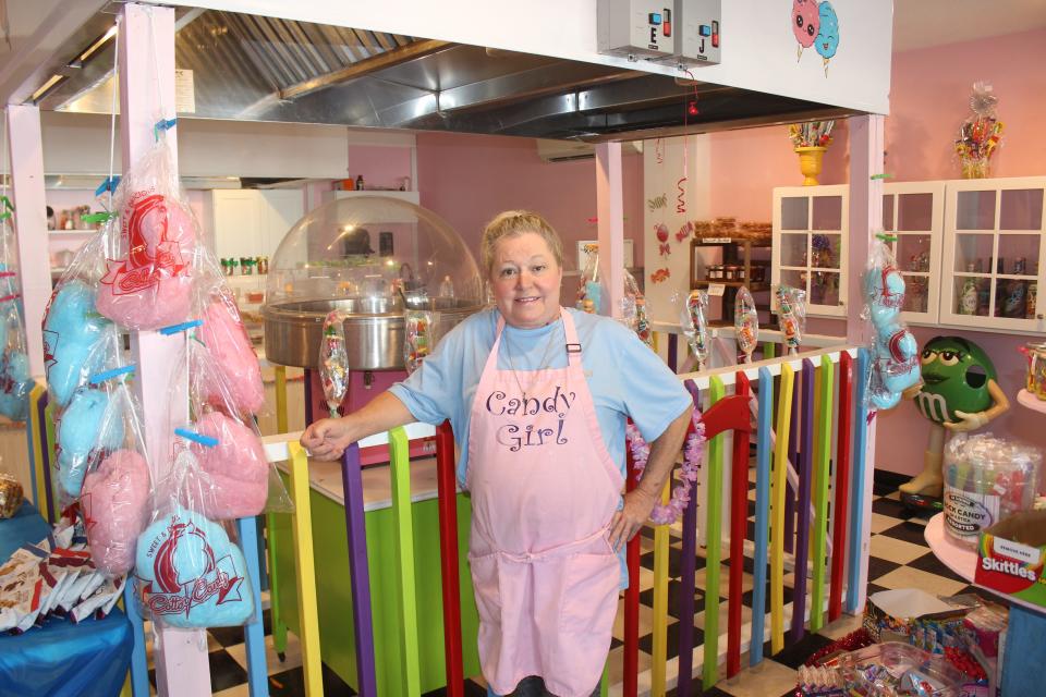 Clarissa Cope poses inside her store, named Candy Girl. In addition to running a business, Cope is the founder of Oak Island Angels, an organization that helps families in the community with Christmas gifts and holiday meals.