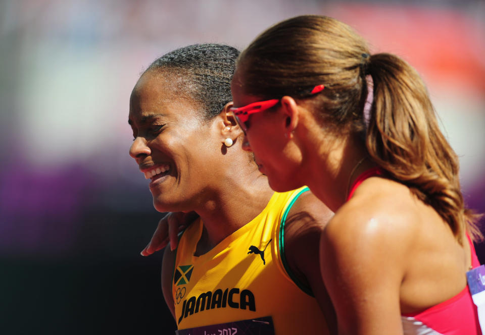 Brigitte Foster-Hylton of Jamaica reacts with Lolo Jones of the United States after competing in the Women's 100m Hurdles heat on Day 10 of the London 2012 Olympic Games at the Olympic Stadium on August 6, 2012 in London, England. (Photo by Stu Forster/Getty Images)