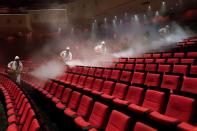 Volunteers from the Blue Sky Rescue team disinfect at the Qintai Grand Theatre in Wuhan