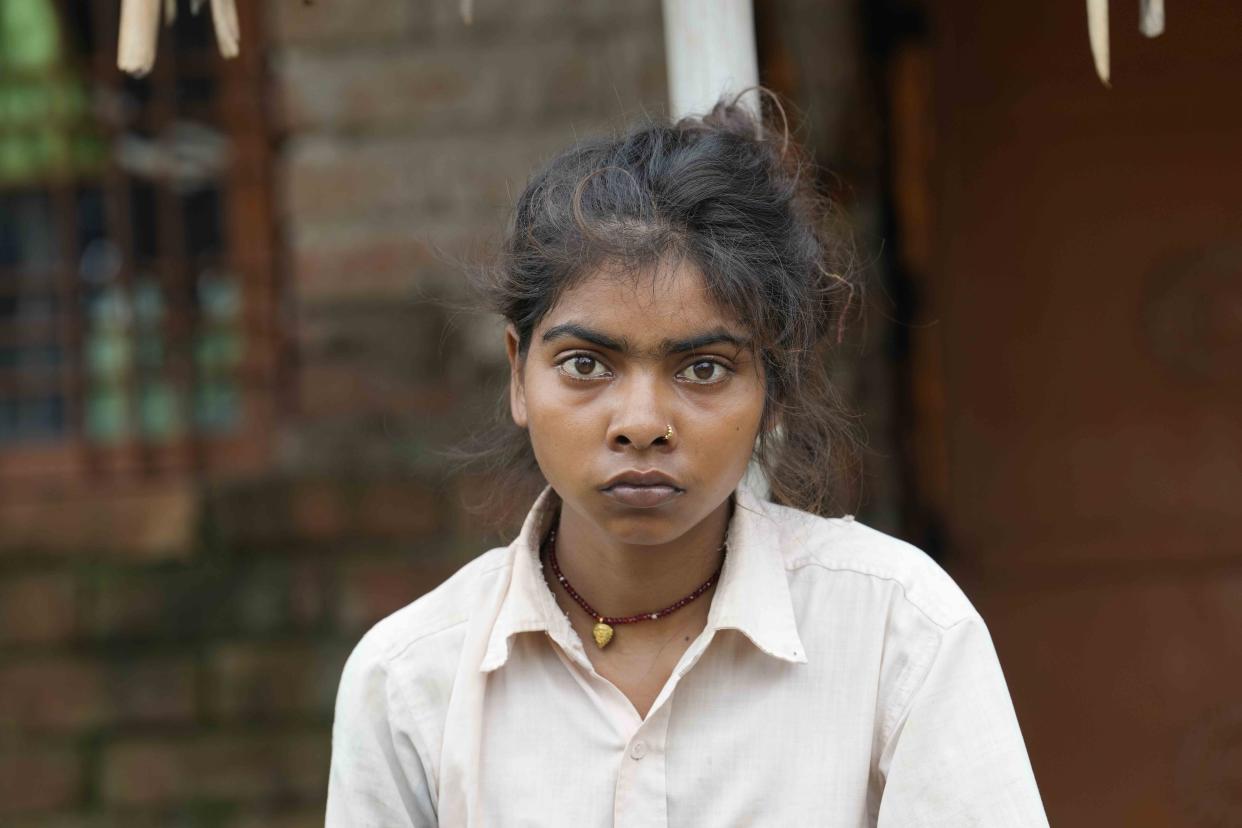 Khushboo Bind, center, sits for a photograph after she was injured by lightning that killed her sister-in-law, also called Khusboo, in a paddy field on June 25, in front of their house at Piparaon village on the outskirts of Prayagraj, in the northern Indian state of Uttar Pradesh, Thursday, July 28, 2022. Seven people, mostly farmers, were killed by lightning in a village in India's northern Uttar Pradesh state, police said Thursday, bringing the death toll by lightning to 49 people in the state this week. (AP Photo/Rajesh Kumar Singh)