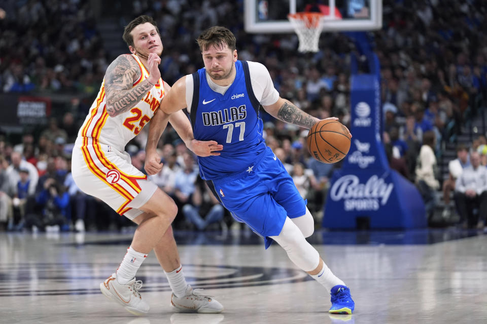 Dallas Mavericks guard Luka Doncic (77) drives against Atlanta Hawks guard Garrison Mathews (25) during the first half of an NBA basketball game in Dallas, Thursday, April 4, 2024. (AP Photo/LM Otero)