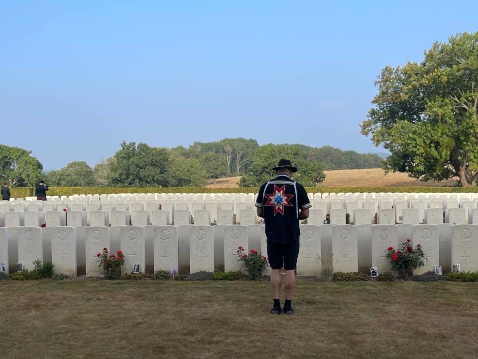 Richard Pellissier-Lush stands a the Dieppe Canadian War Cemetery in Hautot-sur-Mer, France. Six members of the Mi'kmaq Heritage Actors travelled to Dieppe in August to commemorate the 80th anniversary of the raid there that killed thousands of Canadians. (Submitted by Julie Pellissier-Lush - image credit)