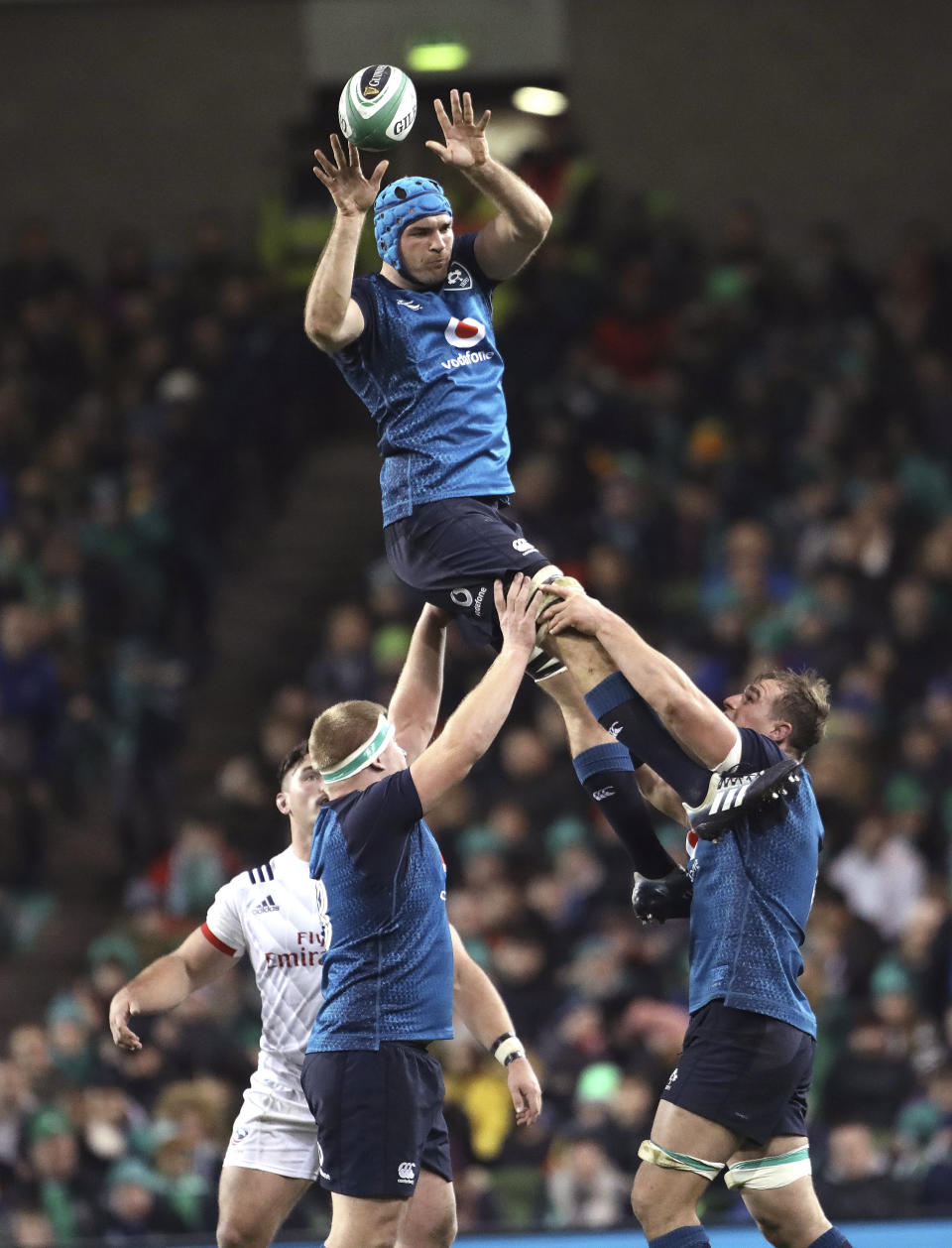 FILE - In this file photo dated Saturday, Nov 24, 2018, Ireland's Tadhg Beirne, top, wins a line out against the USA during their Rugby Union International at the Aviva Stadium, Dublin, Ireland. Ireland lock Tadhg Beirne will get his Six Nations Debut when Ireland meet Wales for the deciding match upcoming Saturday March 16, 2019, with Ireland pressing for its Six Nations Grand Glam. (AP Photo/Peter Morrison, FILE)