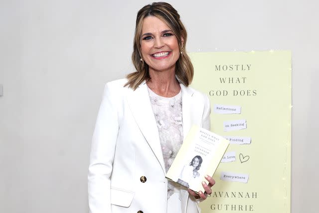 <p>Jamie McCarthy/Getty</p> Savannah Guthrie with her book 'Mostly What God Does'