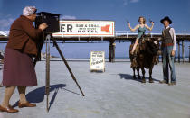 In 1945, this young woman was photographed on the back of Ferdinand the ox while visiting a Florida beach. Instead of beach floats and coolers, she packed twin toy pistols for the staged shot.