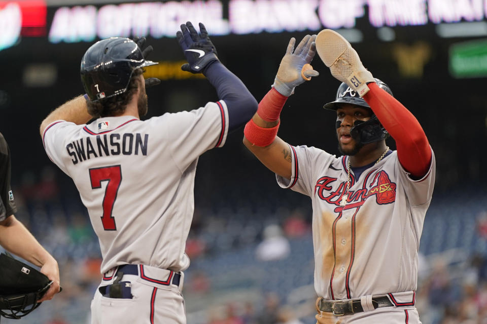 Atlanta Braves' Ronald Acuna Jr. greets teammate Dansby Swanson at home plate after rounding the bases on Swanson's home run in the first inning of a baseball game against the Washington Nationals, Thursday, July 14, 2022, in Washington. (AP Photo/Patrick Semansky)