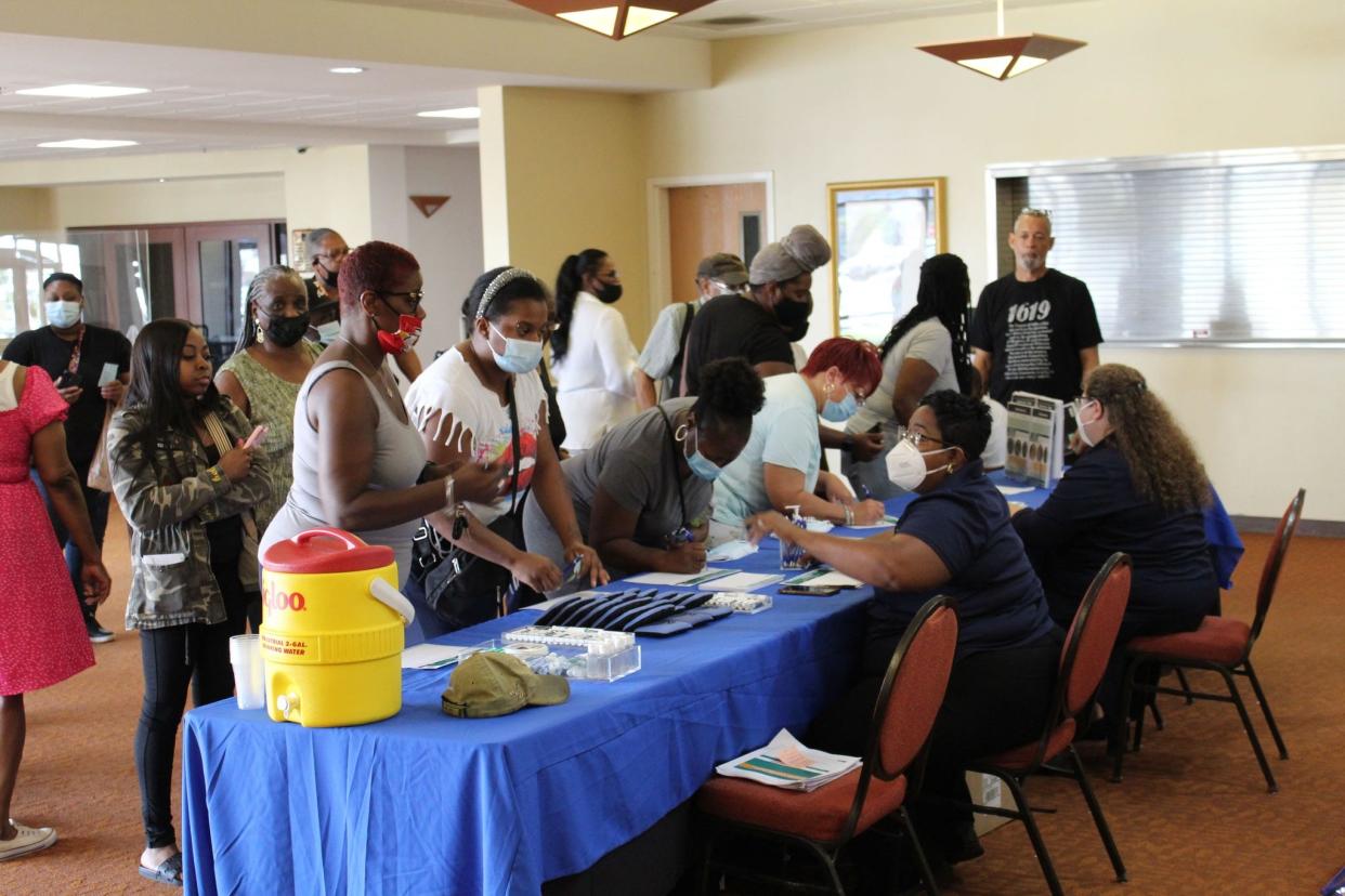 Residents sign-in to learn about the City of Detroit's Lifeline Plan, a water affordability program, at the Fellowship Chapel on August 4.