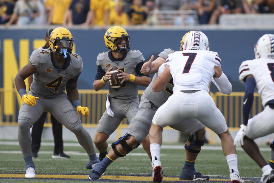 West Virginia Quarterback Garrett Greene (6) looks to pass as C.J. Donaldson (4) looks to block during the first half of an NCAA football game against Duquesne, Saturday, Sept. 9, 2023, in Morgantown, W.Va. (AP Photo/Chris Jackson)