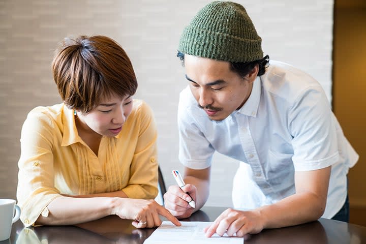 two people looking at a document