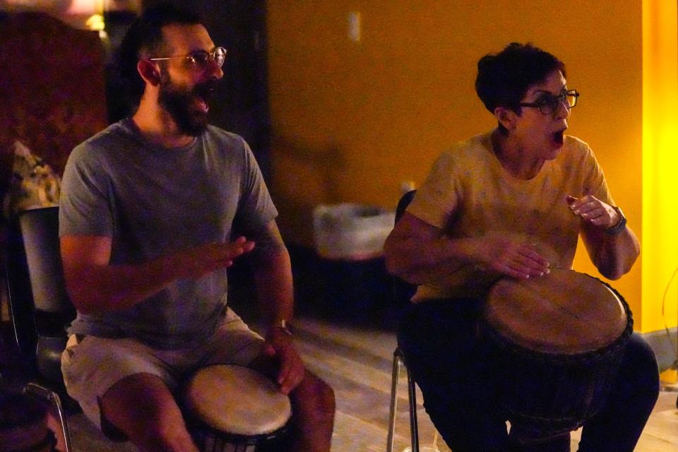 Jeffrey Powers (left) and Chastain Scott participate in a weekly drum circle at Grounded32 in Phoenix on July 25, 2022.