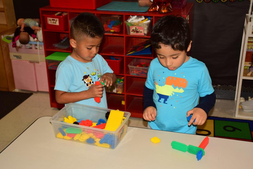 Yulian and Alexander play with Legos at the Inter-Faith Community Preschool in Fort Smith that will close the doors May 17.