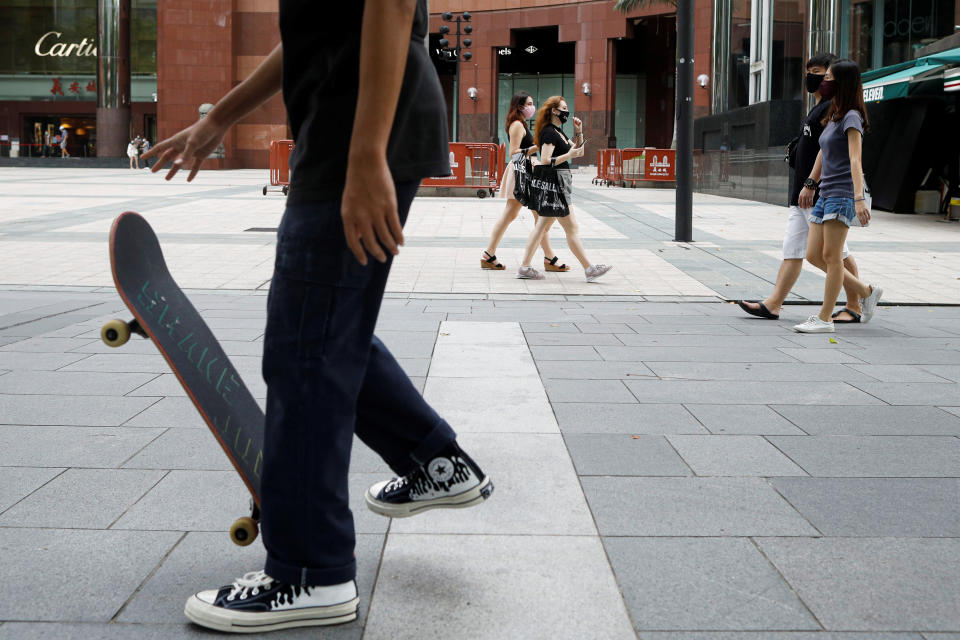 A youth plays skateboard at the shopping district of Orchard Road as the city state reopens the economy, amid the coronavirus disease (COVID-19) outbreak, in Singapore June 19, 2020.  REUTERS/Edgar Su