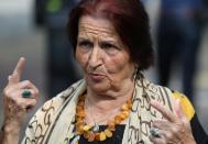 A member of "Mothers of Srebrenica" association talks with the media as she waits for the ruling on the case brought by relatives of the victims of the 1995 Srebrenica massacre, at the Dutch high court in The Hague