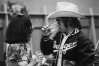 <p>Elton John chats with music journalist Lisa Robinson after a concert on the the Rolling Stones' Tour of the Americas in 1975.</p>