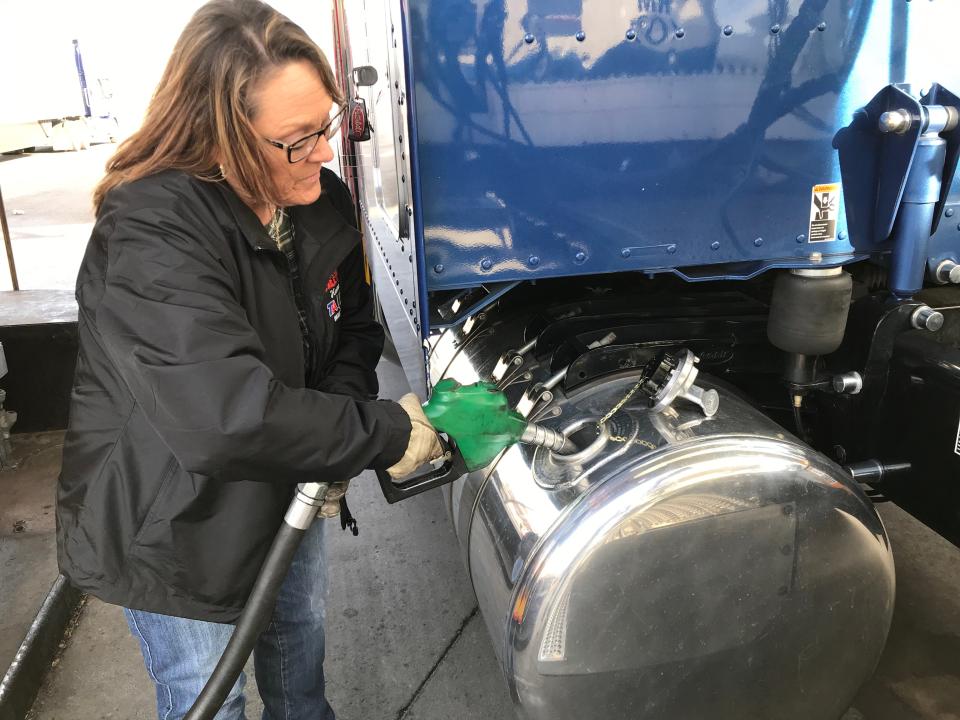 Ingrid Brown tops off her tanks with 92 gallons of diesel at a truck stop in Yuma, Arizona. She's headed east with a load of produce