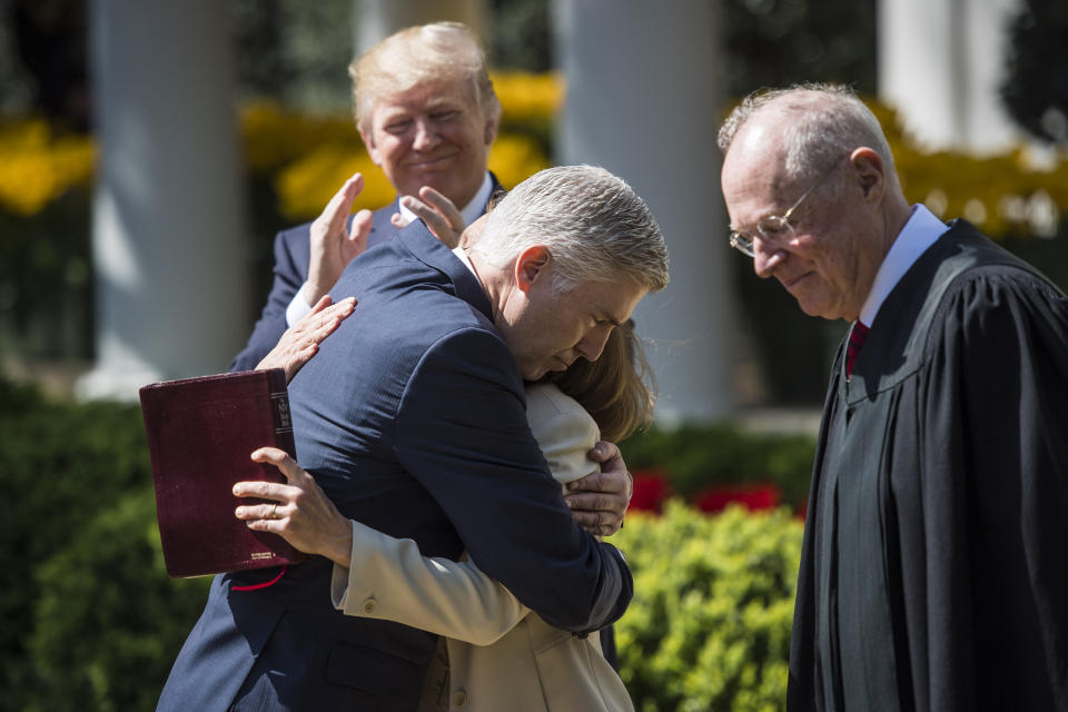 President Donald Trump watches as Supreme Court Justice Neil Gorsuch hugs his wife Marie Louise moments after Supreme Court Justice Anthony Kennedy administered the judicial oath during a swearing-in ceremony in the Rose Garden of the White House in Washington, DC on April 10, 2017. (Photo: Jabin Botsford/The Washington Post via Getty Images)