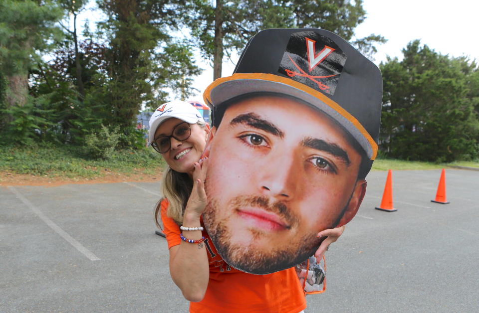 Jeanie Parker holds up a cardboard cutout of her son, Nick, before an NCAA Tournament game last weekend. Nick Parker led Virginia to a 2-1 win over East Carolina Saturday that helped vault the Cavaliers into the NCAA Super Regionals this upcoming weekend.