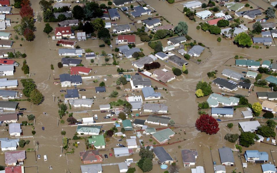 Flooded streets of the North Island town of Edgecumbe in New Zealand - Credit: Andrew Warner/AP