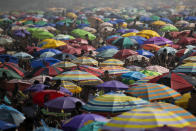 People enjoy the Ipanema beach amid the new coronavirus pandemic in Rio de Janeiro, Brazil, Sunday, Sept.6, 2020. Brazilians are packing the beaches and bars this weekend, taking advantage of a long holiday to indulge in normal life even as the COVID-19 pandemic rages on. (AP Photo/Bruna Prado)