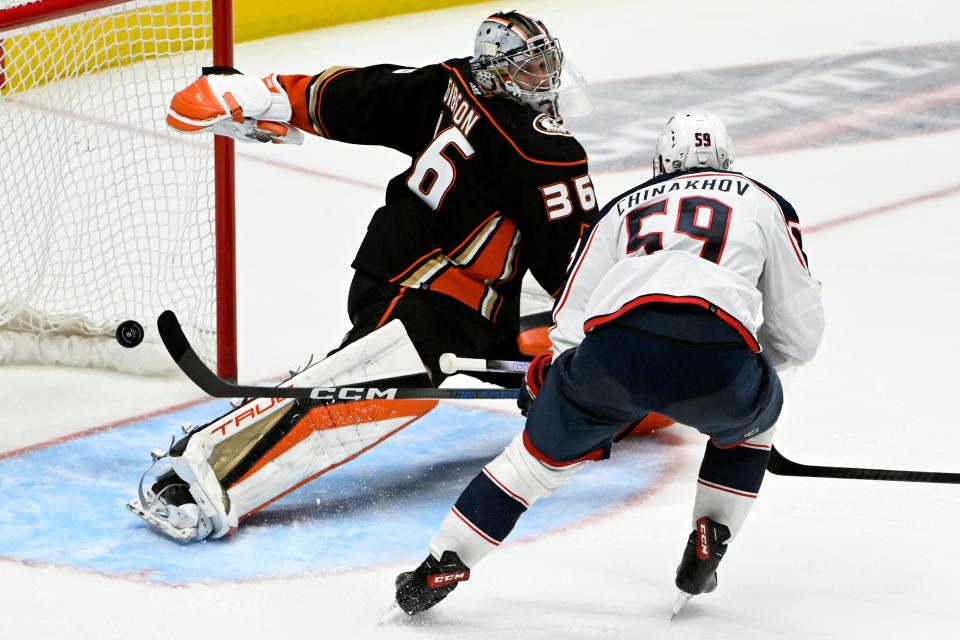 Columbus Blue Jackets right wing Yegor Chinakhov (59) scores against Anaheim Ducks goaltender John Gibson (36) during the third period of an NHL hockey game in Anaheim, Calif., Wednesday, Feb. 21, 2024. (AP Photo/Alex Gallardo)