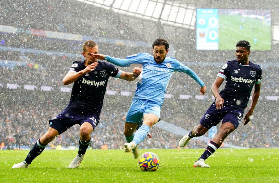 Manchester City’s Bernardo Silva (centre) battled for possession in the snow (Nick Potts/PA) (PA Wire)