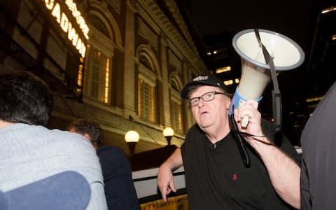Michael Moore leads his Broadway audience to Trump Tower to protest Donald Trump - Credit: Getty Images