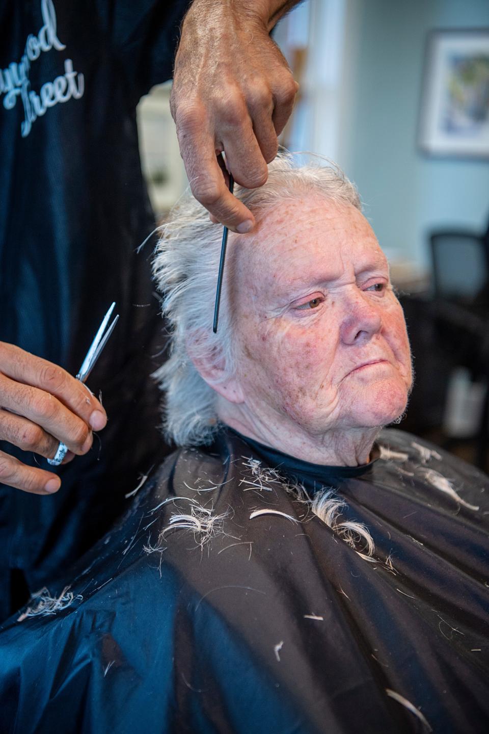 Linda Penland receives a haircut from a volunteer at Haywood Street Congregation, Nov. 8, 2023.