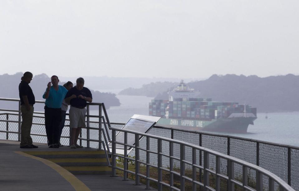 People visit the Panama Canal in Gatun, north from Panama City, Panama, Friday, Jan. 3, 2014. The consortium responsible for most of the expansion of the canal issued an ultimatum giving the Panama Canal Authority under a month to pay for a cost overrun to build a third set of locks, threatening to halt the Panama Canal's expansion. (AP Photo/Arnulfo Franco)