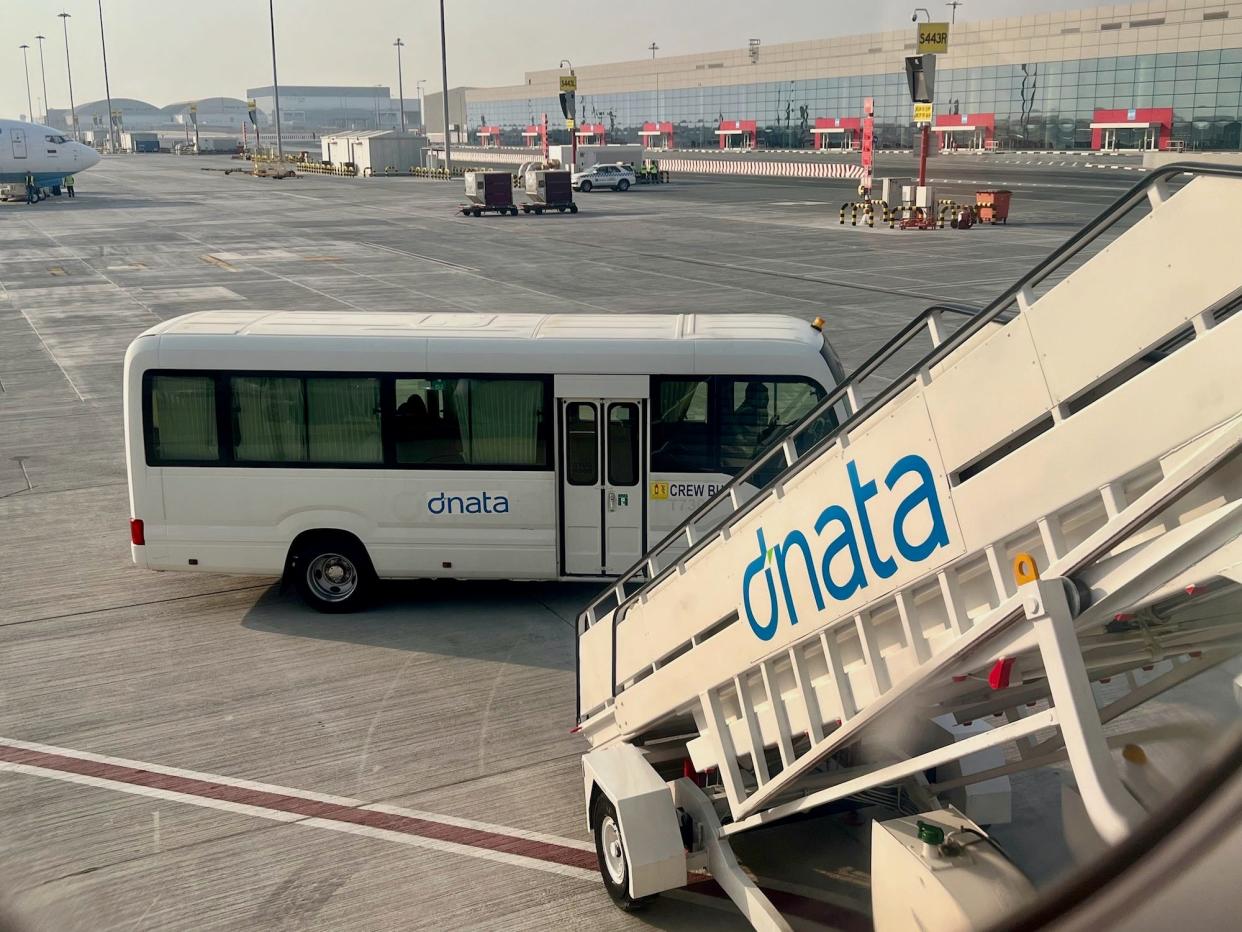 A crew transfer bus at the bottom of the airstairs leading up to the plane in Dubai.